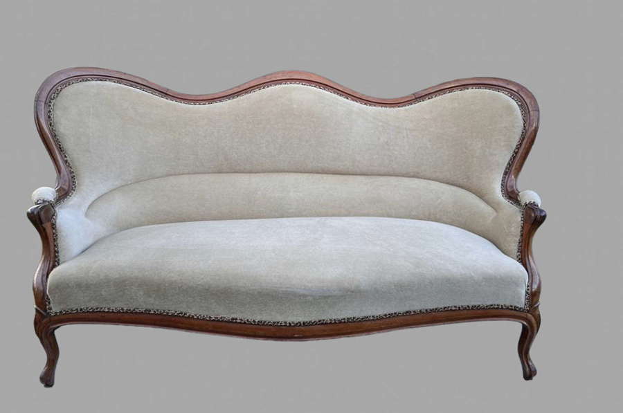 A Victorian Walnut Framed Hump Back Sofa