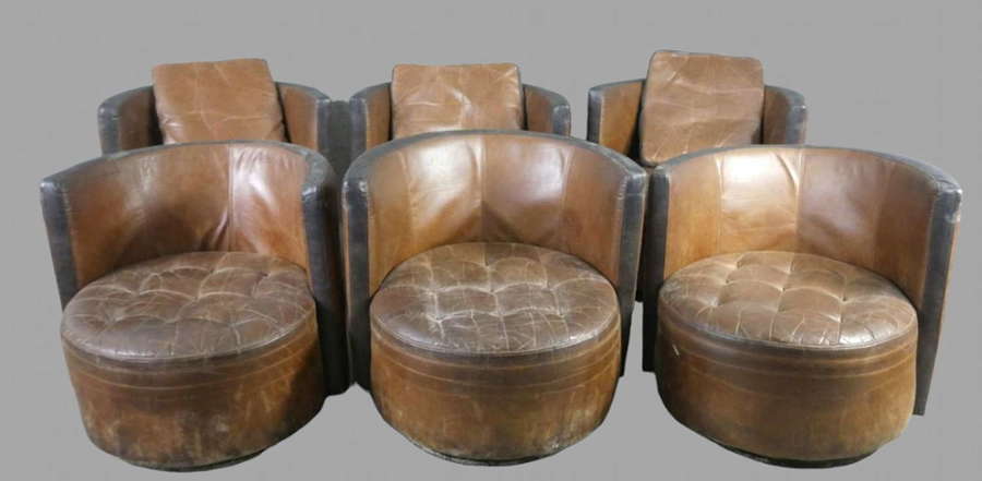 A Set Of Six Brown Leather Swivel Chairs