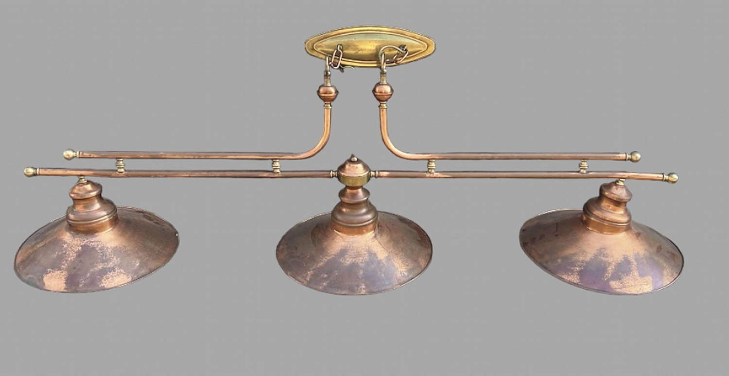 A Cooper and Brass Triple Shade Light Fitting