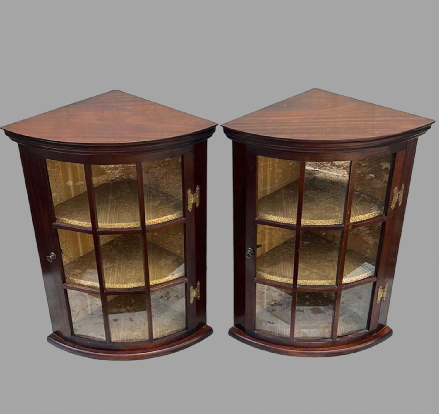 A Pair of Mahogany Corner Cabinets