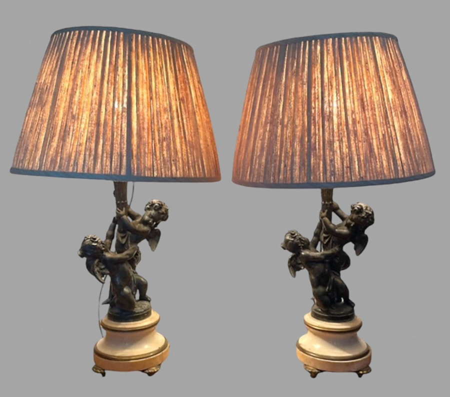 A Pair of Cherub Lamps with Marble and Brass Bases