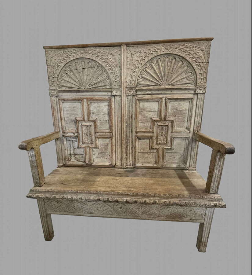 A Highly Decorative Limed Backed Settle